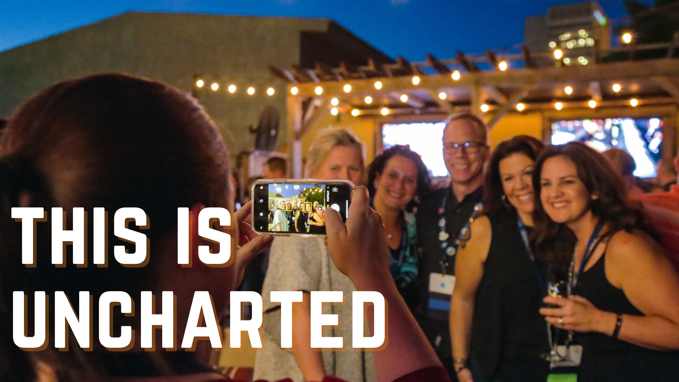 This is Uncharted. Photo of Uncharted conference attendees smiling for a photo to be taken.